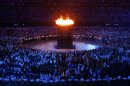 The Olympic cauldron is seen alight during the opening ceremony of the London 2012 Olympic Games