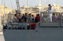 Migrants arrive aboard a Maltese patrol boat at Hay Wharf in Valletta, on October 12, 2013