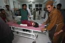 An Afghan girl is wheeled in for treatment at a hospital after a roadside bomb in Herat province