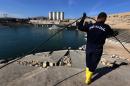 An employee works at strengthening the Mosul Dam on the Tigris River, on February 1, 2016