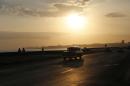 A taxi driver steers his classic American car along the Malecon at sunrise in Havana, Cuba, Wednesday, April 15, 2015. Cuban officials and ordinary citizens alike hailed the island's removal from the U.S. list of state sponsors of terrorism, saying the move by President Barack Obama heals a decades-old insult to national pride and clears the way to swiftly restore diplomatic relations. (AP Photo/Desmond Boylan)