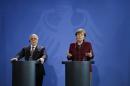 German Chancellor Angela Merkel, right, and Iraqi Prime Minister Haider al-Abadi, left, attend a joint press conference at the chancellery in Berlin, Thursday, Feb. 11, 2016. (AP Photo/Markus Schreiber)