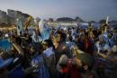 Argentine soccer fans celebrate, one day before the 2014 Soccer World Cup debut of their team, on Copacabana beach, in Rio de Janeiro, Brazil, Saturday, June 14, 2014. Argentina will play in group F of the tournament. (AP Photo/Leo Correa)
