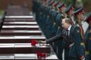Russian Vladimir Putin, second right, takes part in a wreath laying ceremony at the Tomb of the Unknown Soldier outside Moscow's Kremlin Wall, in Moscow, Russia, Sunday, June 22, 2014, to mark the 73rd anniversary of the Nazi invasion of the Soviet Union. (AP Photo/Alexander Zemlianichenko)