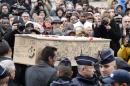 The coffin of Bernard "Tignous" Verlhac, 57, one of the French satirical weekly Charlie Hebdo's cartoonists, is carried out of the town hall of Montreuil, near Paris, during his funeral on January 15, 2015