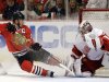 Detroit Red Wings goalie Jimmy Howard, right, saves a shot by Chicago Blackhawks' Jonathan Toews, left, during the second period of Game 5 of the NHL hockey Stanley Cup playoffs Western Conference semifinals in Chicago, Saturday, May 25, 2013. (AP Photo/Nam Y. Huh)