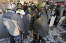 Ukrainian protesters hold makeshift shields and batons in their camp on Independence Square in Kiev, on January 25, 2014