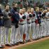 The Boston Red Sox players and coaches observe a moment of silence for the victims of the Boston bombings before a baseball game  against the Cleveland Indians Tuesday, April 16, 2013, in Cleveland. (AP Photo/Mark Duncan)