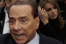 Former Italian premier Silvio Berlusconi arrives at Milan's central train station, Italy, Saturday, Dec. 29, 2012. Italian Premier Mario Monti announced Friday he is heading a new campaign coalition made of up centrists, business leaders and pro-Vatican forces who back his "ethical" vision of politics, aiming for a second mandate in office if his fledging reform movement wins big in parliamentary elections. Monti was appointed premier 13 months ago after his scandal-plagued predecessor Silvio Berlusconi failed to stop Italy from sliding deeper into the eurozone debt crisis. He quit earlier this month after Berlusconi pulled his party's support from Monti's government, but is now continuing in a caretaker role until the next elections. (AP Photo/Luca Bruno)