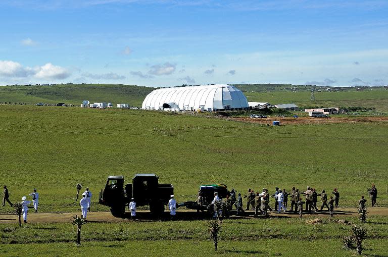 The funeral procession carrying the coffin of South African President Nelson Mandela moves inside his compound in the village of Qunu on December 15, 2013