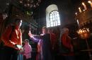 Christian worshipers take photos inside the Church of the Nativity, believed to be the birthplace of Jesus Christ, in the West Bank biblical town of Bethlehem, on December 23, 2014