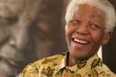 FILE - In this Dec. 7, 2005, file photo, former South African President Nelson Mandela, 87, is in a jovial mood at the Mandela Foundation in Johannesburg, where he met with the winner and runner-up of the local "Idols" competition. South Africa's president says, Thursday, Dec. 5, 2013, that Mandela has died. He was 95. (AP Photo/Denis Farrell, File)