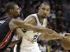 San Antonio Spurs' Tim Duncan (21) drives past Miami Heat's Chris Bosh (1) during the first half at Game 5 of the NBA Finals basketball series, Sunday, June 16, 2013, in San Antonio. (AP Photo/Eric Gay)