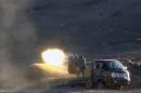 Syrian rebel fighters fire a heavy machinegun against Islamic State positions from a location west of Kobani during fighting