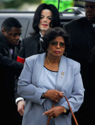 FILE - In this Monday, Feb. 28, 2005 file photo, Michael Jackson follows his mother, Katherine Jackson, as they arrive for court on the opening day of his child molestation trial at Santa Barbara County Superior Court in Santa Maria, Calif. Opening statements are scheduled to begin Monday April 29, 2013, in Katherine Jackson’s lawsuit against concert giant AEG Live over Michael’s 2009 death. Katherine Jackson claims the company failed to properly investigate the doctor who was convicted in 2011 of involuntary manslaughter for the singer’s death, but the company denies all wrongdoing. (AP Photo/Marcio Jose Sanchez, File)