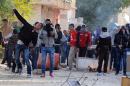Tunisian protesters hurl stones towards police during clashes after a demonstration against the country's ruling Islamist Ennahda party in Siliana, northwest of Tunis, on November 27, 2013