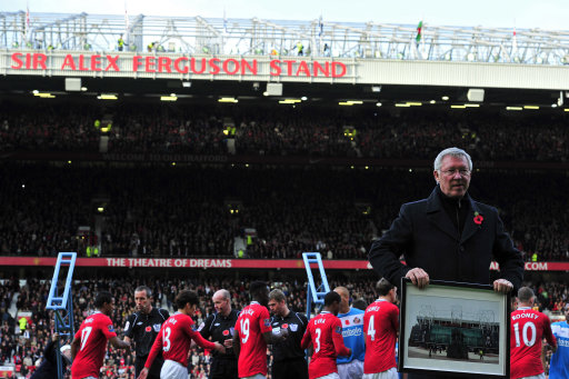 Manchester United's Scottish manager Sir Alex Ferguson (R) is honoured by having the North Stand named after him as he celebrates 25 years in charge before the English Premier League football match between Manchester United and Sunderland at Old Trafford in Manchester, north-west England on November 5, 2011. AFP PHOTO/GLYN KIRK RESTRICTED TO EDITORIAL USE. No use with unauthorized audio, video, data, fixture lists, club/league logos or ldquo;liverdquo; services. Online in-match use limited to 45 images, no video emulation. No use in betting, games or single club/league/player publications (Photo credit should read GLYN KIRK/AFP/Getty Images)