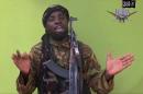 FILE -This May 12, 2014, file photo taken from video by Nigeria's Boko Haram terrorist network, shows their leader Abubakar Shekau speaking to the camera. Islamic State militants have accepted a pledge of allegiance by the Nigerian-grown Boko Haram extremist group, a spokesman for the Islamic State movement said Thursday, March 12, 2015. On Saturday, Shekau posted an audio recording online that pledged allegiance to IS. On Thursday, the Islamic State group's media arm Al-Furqan, in an audio recording by spokesman Abu Mohammed al-Adnani, said that Boko Haram's pledge of allegiance has been accepted, claiming the caliphate has now expanded to West Africa. (AP Photo/File)