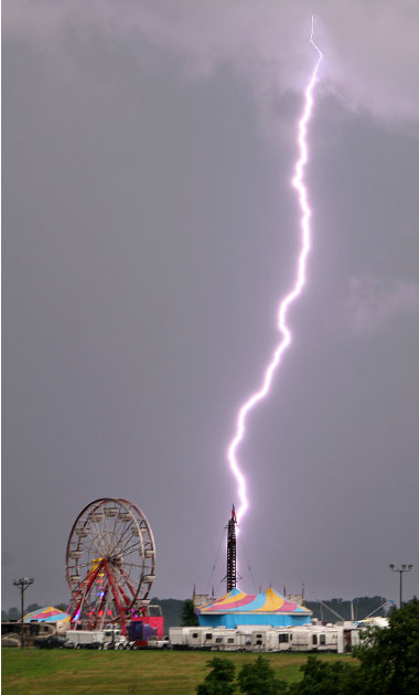 A lightning bolt strikes near the Dubuque County Fair Wednesday night, July 27, 2011 during a storm in Dubuque, Iowa. Dubuque County was under a tornado warning Wednesday night. (AP Photo/The Telegrap
