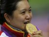 China's Guo Wenjun bites her gold medal at the victory ceremony for the women's 10m Air Pistol competition at the London 2012 Olympic Games