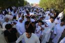 Mourners carry the body of one of the victims of the Al-Imam Al-Sadeq mosque bombing, during a mass funeral at Jaafari cemetery in Kuwait City on June 27, 2015