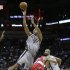 San Antonio Spurs' Tim Duncan (21) is hit by Washington Wizards' Garrett Temple (17) as he shoots during the first half of an NBA basketball game on Saturday, Feb. 2, 2013, in San Antonio. (AP Photo/Eric Gay)