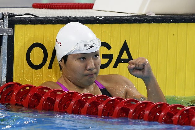 Singapores Tao Li competes on the way to winning the womens 100-meter butterfly race during the 27th Southeast Asian Games in Naypyitaw, Myanmar, Saturday, Dec 14, 2013. (AP Photo/Vincent Thian)