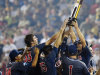 Arizona players hoist the trophy after defeating South Carolina 4-1 in Game 2 to win the NCAA College World Series baseball finals in Omaha, Neb., Monday, June 25, 2012. (AP Photo/Eric Francis)
