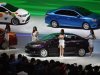 Models pose by Toyota cars during the 15th Shanghai International Automobile Industry Exhibition in Shanghai