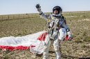 In this photo provided by Red Bull Stratos, Pilot Felix Baumgartner of Austria celebrates after successfully completing the final manned flight for Red Bull Stratos in Roswell, N.M., Sunday, Oct. 14, 2012. Baumgartner came down safely in the eastern New Mexico desert minutes about nine minutes after jumping from his capsule 128,097 feet, or roughly 24 miles, above Earth. (AP Photo/Red Bull Stratos, Balazs Gardi)