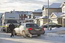 Police investigate the scene where multiple deaths occurred overnight in Edmonton, Alberta, Tuesday, Dec. 30, 2014. (AP Photo/The Canadian Press, Jason Franson)