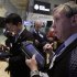 In this May 30, 2012 photo, Richard Cohen, right, works with fellow traders on the floor of the New York Stock Exchange. U.S. futures augured a lower opening on Wall Street Friday June 1, 2012.   (AP Photo/Richard Drew)
