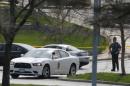 A Kansas State Trooper stands near the location of a shooting at the Jewish Community Center in Overland Park, Kan., Sunday, April 13, 2014. (AP Photo/Orlin Wagner)