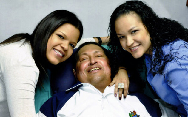 Venezuela's President Hugo Chavez smiles in between his daughters, Rosa Virginia (R) and Maria while recovering from cancer surgery in Havana in this photograph released by the Ministry of Information on February 15, 2013. Venezuela's government published the first pictures of cancer-stricken Chavez since his operation in Cuba more than two months ago, showing him smiling while lying in bed reading a newspaper, flanked by his two daughters. The 58-year-old socialist leader had not been seen in public since the Dec. 11 surgery, his fourth operation in less than 18 months. The government said the photos were taken in Havana on February 14, 2013.   REUTERS/Ministry of Information/Handout (VENEZUELA - Tags: POLITICS PROFILE TPX IMAGES OF THE DAY HEALTH)  ATTENTION EDITORS - THIS IMAGE WAS PROVIDED BY A THIRD PARTY. FOR  EDITORIAL USE ONLY. NOT FOR SALE FOR MARKETING OR ADVERTISING CAMPAIGNS. THIS PICTURE IS DISTRIBUTED EXACTLY AS RECEIVED BY REUTERS, AS A SERVICE TO CLIENTS