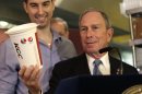 FILE - In this March 12, 2013 file photo, New York City Mayor Michael Bloomberg looks at a 64oz cup, as Lucky's Cafe owner Greg Anagnostopoulos, left, stands behind him. An appeals court ruled Tuesday, July 30, 2013 that New York City's Board of Health exceeded its legal authority and acted unconstitutionally when it tried to put a size limit on soft drinks served in city restaurants. (AP Photo/Seth Wenig, File)