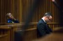 Oscar Pistorius, on his arrival in court for his ongoing murder trial in Pretoria, South Africa, Tuesday, May 13, 2014. Pistorius is charged with the shooting death of his girlfriend Reeva Steenkamp on Valentine's Day in 2013. (AP Photo/Daniel Born, Pool)