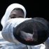 Egypt's El Gammal puts on her mask as she competes against Lebanon's Shaito during their women's Individual Foil round of 64 competition at the ExCel venue at the London 2012 Olympic Games