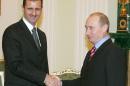 Russia's President Vladimir Putin (right) shakes hands with his Syrian counterpart Bashar al-Assad during a 2006 meeting at the Kremlin in Moscow