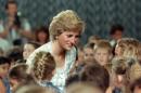Princess of Wales Diana chats with children on November 6, 1989, during her visit to the British international school in Jakarta