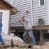 Workers dismantle shattered concrete in front of a storm-wrecked house on the beachfront in Manasquan, N.J., Saturday, May 25, 2013. Communities that were hard-hit by Superstorm Sandy, including Manasquan, are hoping for a profitable summer season to help them recover. (AP Photo/Wayne Parry)