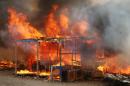 A fire burns at the "Jungle" migrant camp in Calais, northern France, on October 26, 2016