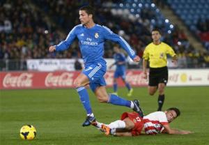 Real Madrid's Ronaldo is challenged by Almeria's Suso …
