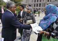 Istar Abdi, right, a member of the Minneapolis Somali community, right,   shakes
 hands
 with U.S. Attorney B.Todd Jones, left, after a federal jury in Minneapolis on Thursday, Oct. 18, 2012
 convicted Mahamud Said Omar on all five terrorism-related charges of helping send young men through a terrorist pipeline from Minnesota to Somalia. Abdi, a mom, said she attended the sentencing to get feedback and to hear the jury's verdict. In center is Amal Ibrahim, a Somali interpreter for the trial. (AP Photo/Jim Mone)