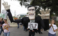 Protest marchers move with a puppet depicting Republican presidential candidate and former Massachusetts Gov. Mitt Romney during a march, Sunday, Aug. 26, 2012, in Tampa, Fla. Hundreds of protestors gathered in Gas Light Park in downtown Tampa to march in demonstration against the Republican National Convention. (AP Photo/Chris O'Meara)
