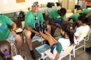 In this photo provided by Todd Buelow, New York Jets offensive tackle Breno Giacomini visits an orphanage in Rio de Janeiro, Brazil, in Feb. 2014. Giacomini and several other NFL players, as part of American Football Without Barriers, visited an orphanage and donated nearly 180 pairs of shoes to the children there. The players washed the children's feet and gave them clean socks and shoes. (Todd Buelow via AP)