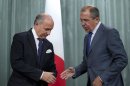 French Foreign Minister Laurent Fabius, left, and his Russian counterpart Sergey Lavrov shake hands at the end of their news conference after their meeting in Moscow, Russia, on Tuesday, Sept. 17, 2013. Moscow is insisting that a new United Nations resolution on Syria not allow the use of force, but Russia's foreign minister appears to suggest the issue could be reconsidered if Syria violates an agreement on abandoning its chemical weapons. (AP Photo/Ivan Sekretarev)