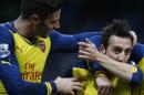 Arsenal's Santi Cazorla, right celebrates with teammate Arsenal's Olivier Giroud after scoring the opening goal from the penalty spot during the English Premier League soccer match between Manchester City and Arsenal at the Etihad Stadium, Manchester, England, Sunday, Jan. 18, 2015. Arsenal won the match 2-0 with Giroud scoring the second goal. (AP Photo/Jon Super)