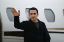 Amir Hekmati waves after arriving on a private flight at Bishop International Airport, Thursday, Jan. 21, 2016, in Flint, Mich. The 32-year-old Hekmati, a former U.S. Marine who was released from an Iranian prison as part of a deal with Iran is returning to home to Michigan. (AP Photo/Paul Sancya)