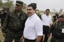 Honduras' President Hernandez talks to officers of Honduras' army during a presentation in Mateo