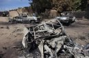 Charred out pickup trucks destroyed by French airstrikes are seen in Diabaly